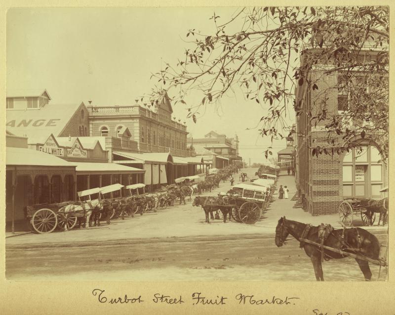 This is an image of ‘Fruit market on Turbot Street in Brisbane, September 1907’, viewed from the corner of Turbot and Roma streets, Brisbane, looking south-west.