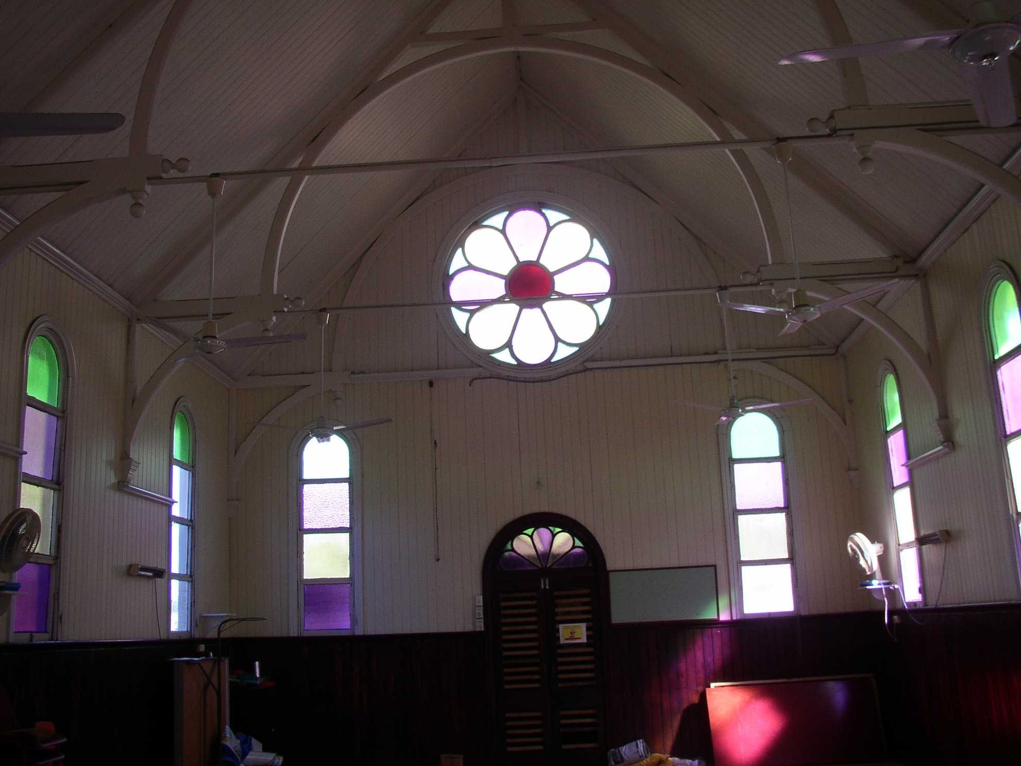 This is an image of the local heritage place known as Bald Hills Presbyterian Church Interior, showing rose window at the front of the church and cedar panelling