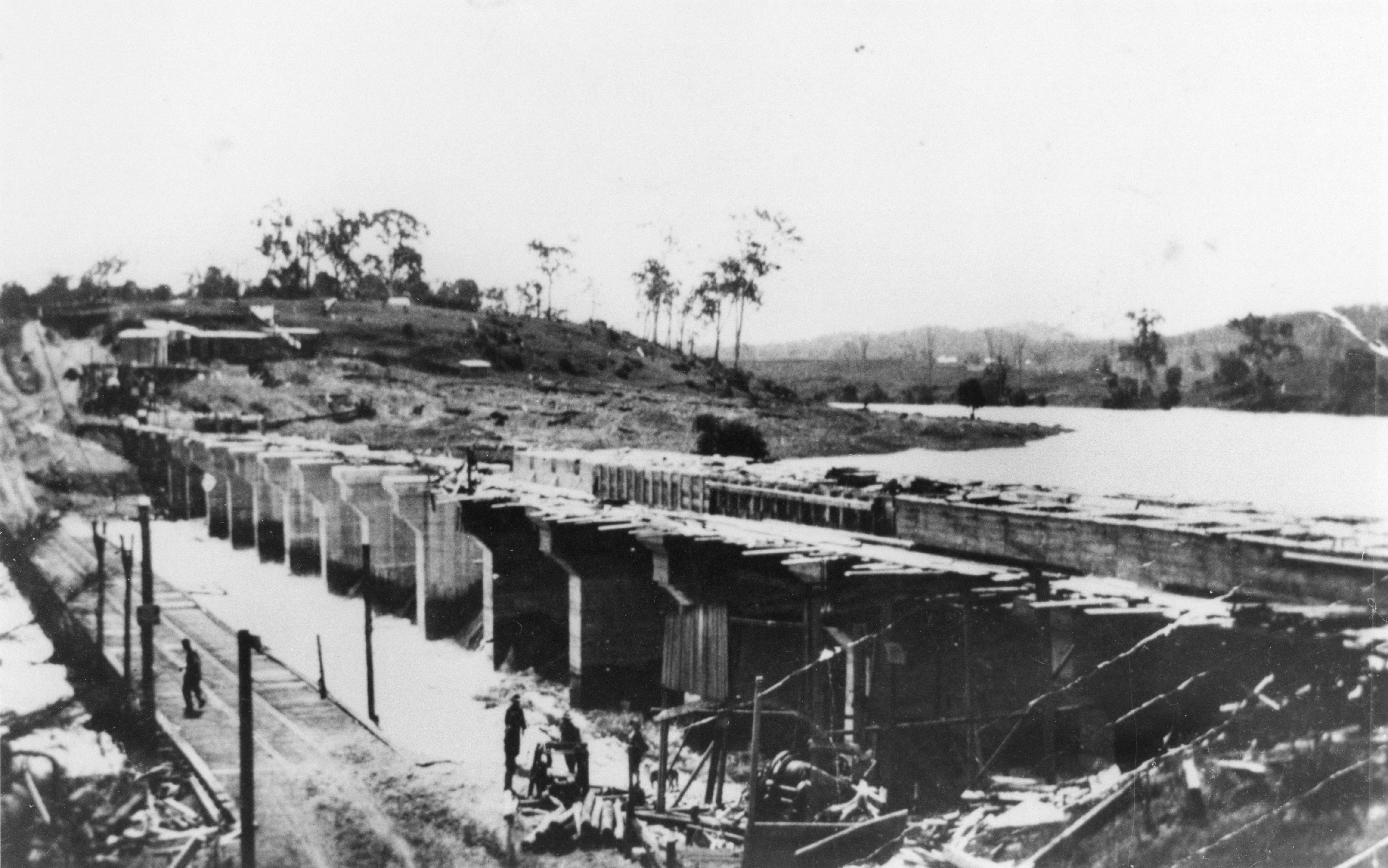 This is a historical image of the Weir and Bridge over the Brisbane River at Mount Crosby, 1926 (2007): Digitised Copy Print from 7499 Photograph Albums of the Mount Crosby Pumping Station.