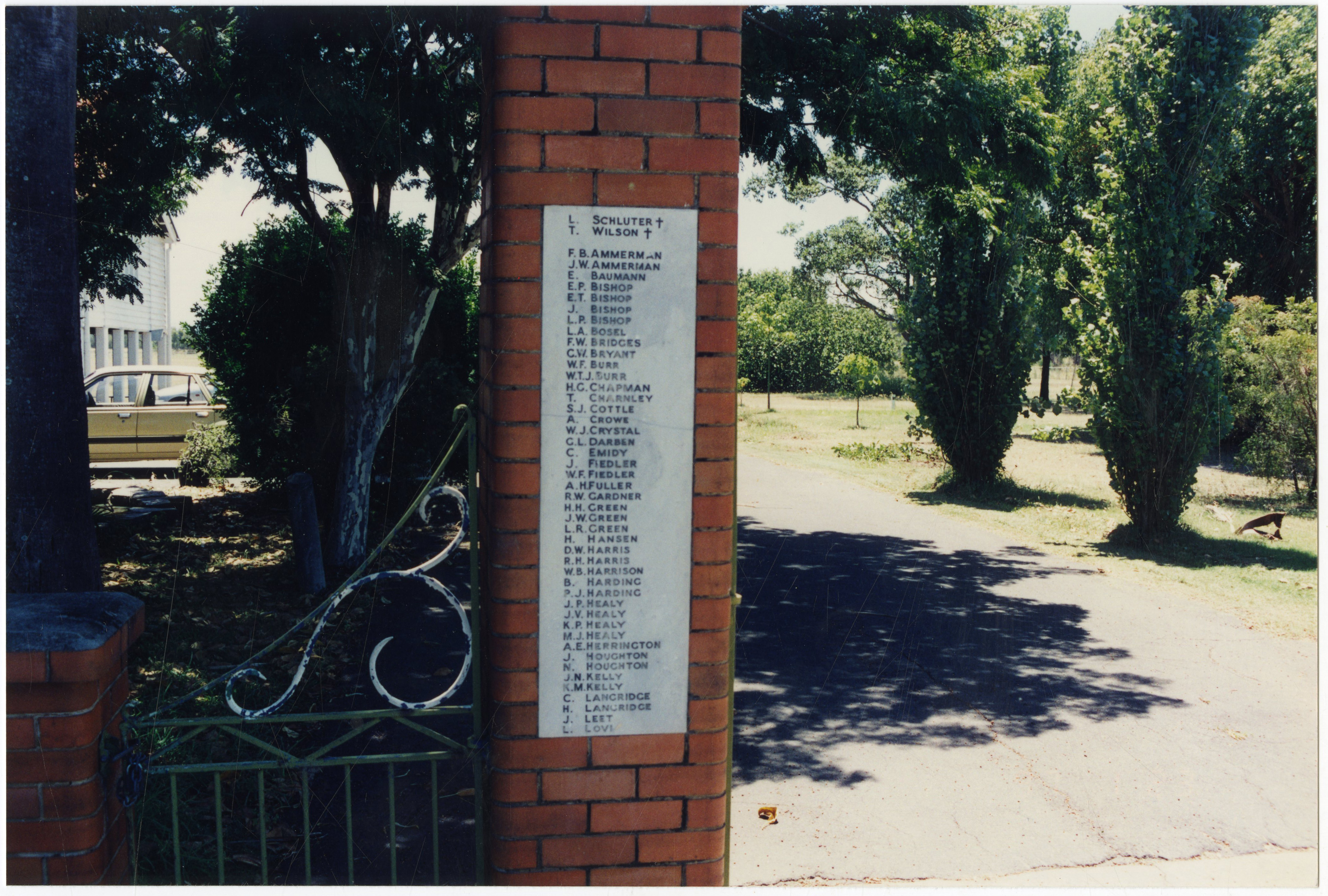 This is an image of the local heritage place known as Pinkenba State School. This image shows detail of the plaque on the left side of the memorial gates.