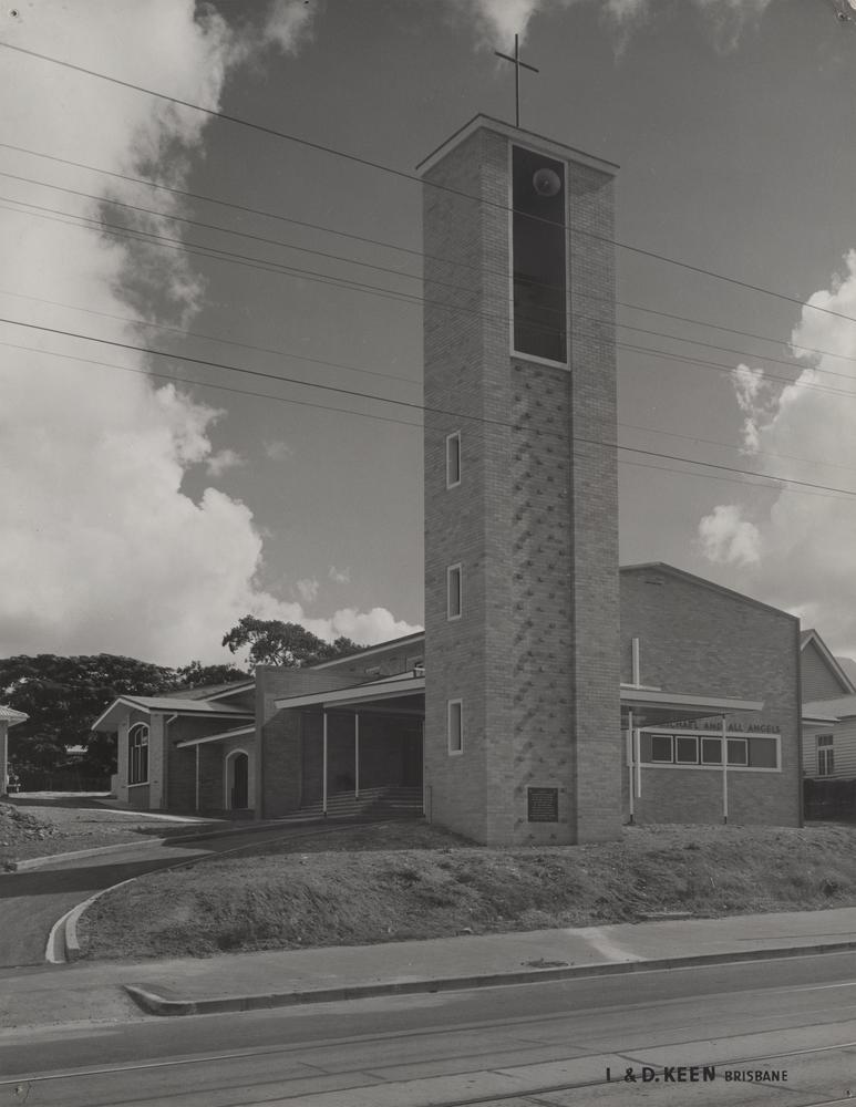 This is an image of ‘St. Michael and All Angels' Anglican Church in New Farm, Queensland’, c.1955-1975, viewed from Brunswick Street, New Farm, looking west