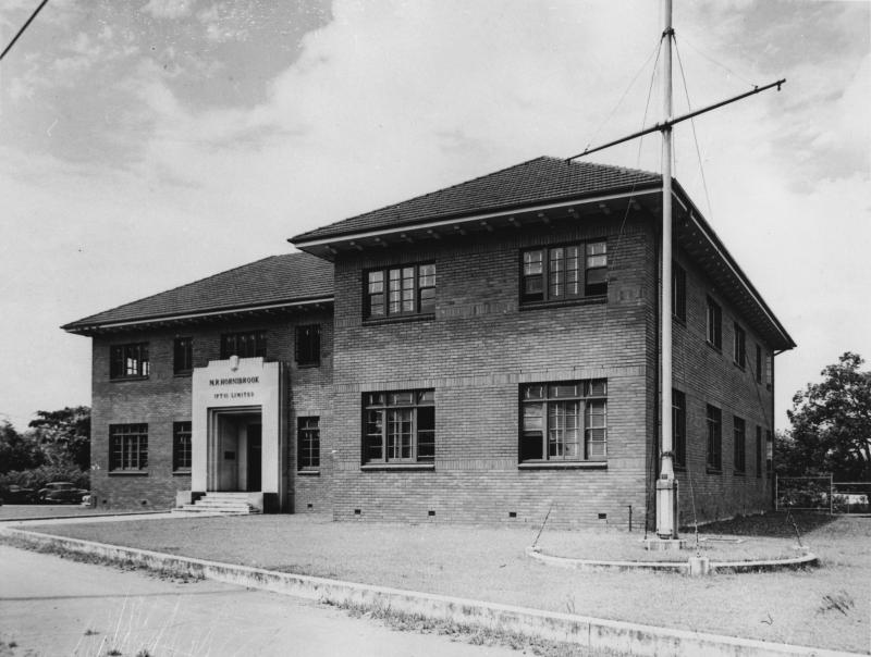 This is an image of 'Headquarters of M.R. Hornibrook (Pty) Limited in Newstead, Brisbane, ca. 1945', viewed from the corner of Breakfast Creek Road & Halford Street, Newstead, looking north-east.